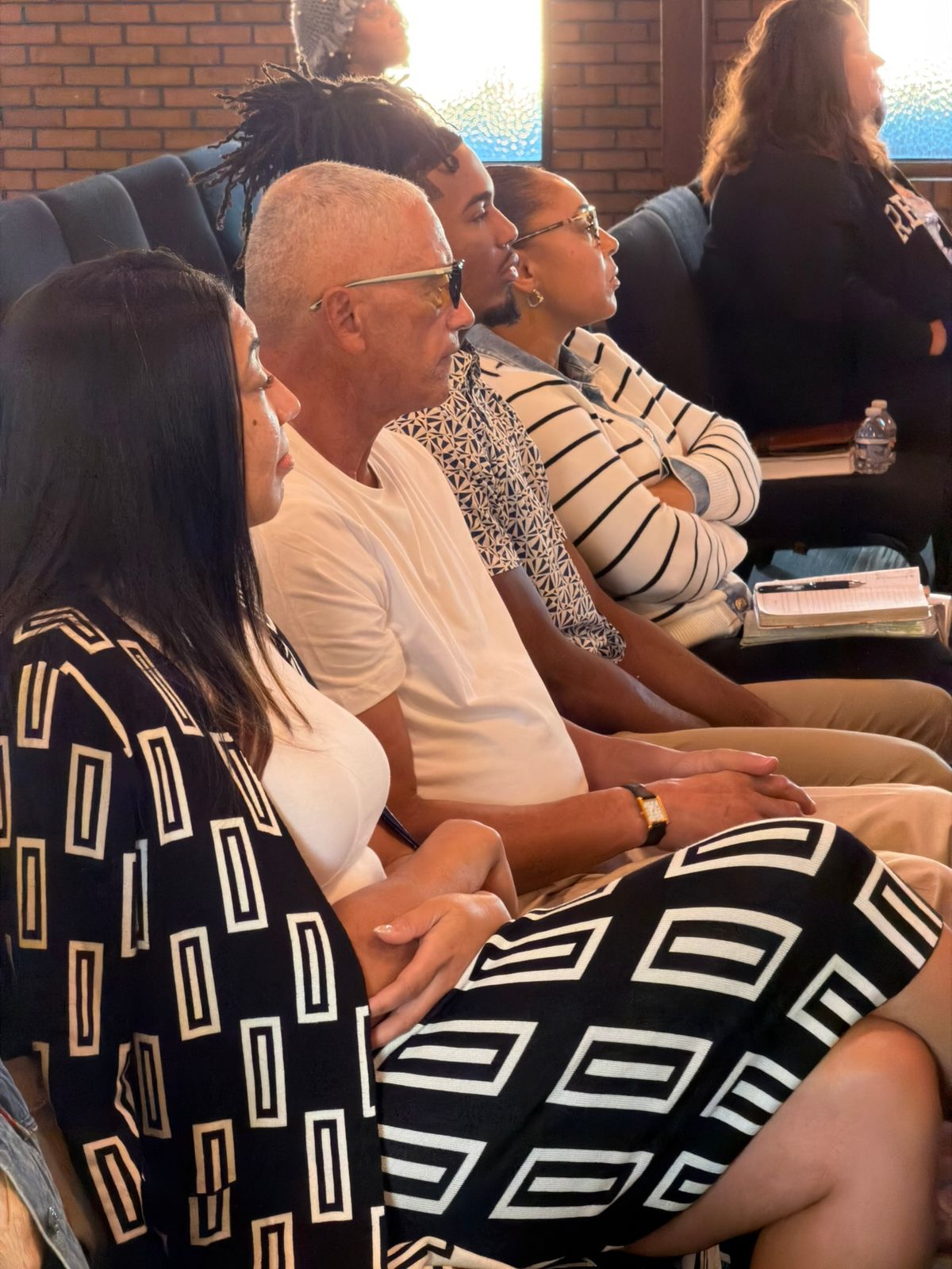 Members listening and taking notes during teaching