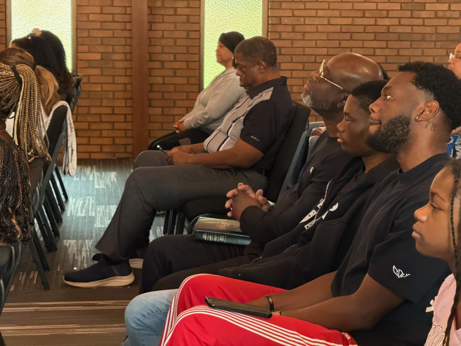 Members seated and listening attentively to teaching